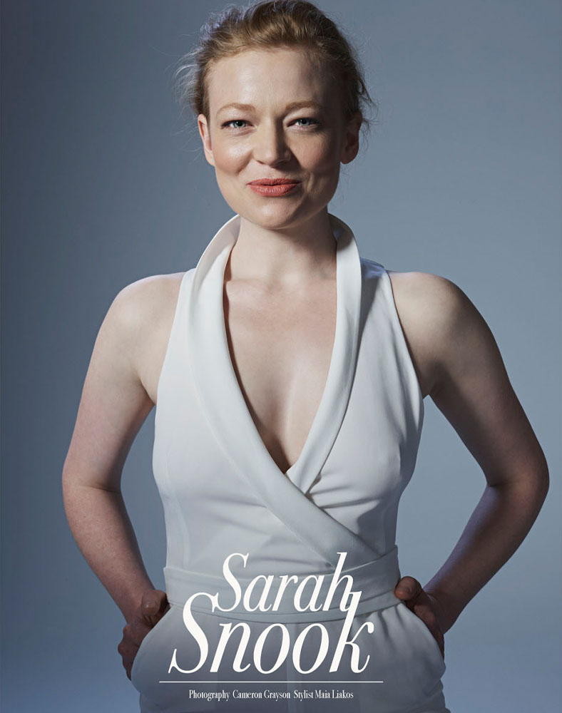 Headshot of Sarah Snook, red-haired adult female celebrity, wearing a light-colored dress and posing indoors in a photo studio.