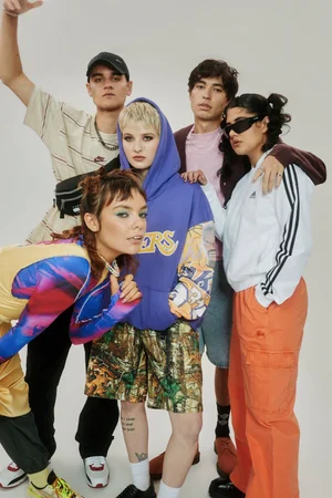 Group of five young people in casual streetwear posing against a plain light background photographed by Claire Wallman for Netflix