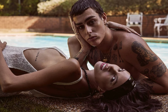 Man and woman lounging poolside with tattoos, styled by Patrick Zaczkiewicz