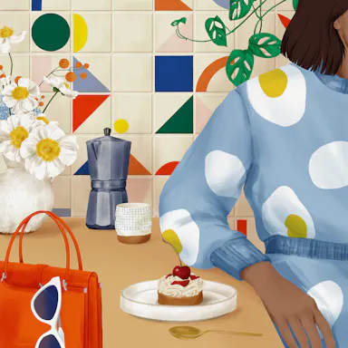 Illustration of a woman in a blue dress sitting at a table with a cupcake, coffee pot, and flowers, against a colorful tiled wall.
