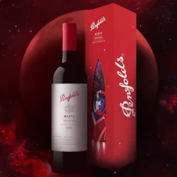Penfolds Max's Shiraz red wine bottle and matching red rocket-illustrated gift box against a deep red space background