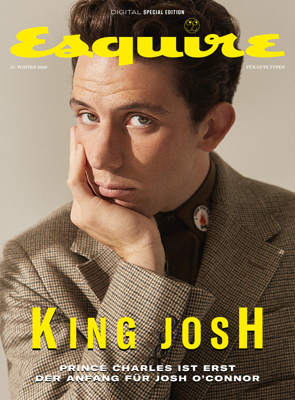 Josh O'Connor on the cover of Esquire. The actor is wearing a suit and collared shirt while resting his face on his hand.