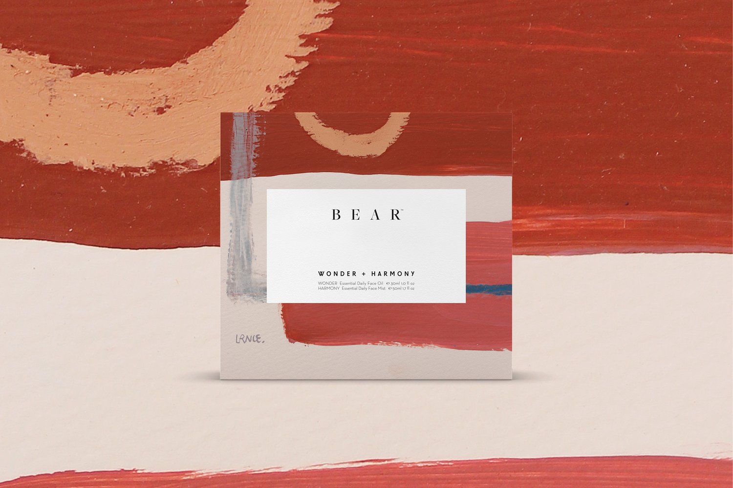 Product shot of a box of BEAR Wonder + Harmony essential oils featuring abstract art and earth tones in a studio setting.