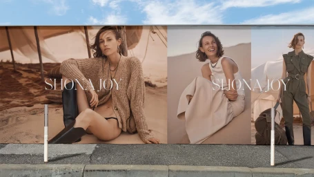 Outdoor billboard display in Sydney featuring three panels with fashion photography by Emil Vrisakis showing models in desert settings
