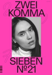 Portrait of a woman with dark hair in a white turtleneck against a bright pink typographic poster background.