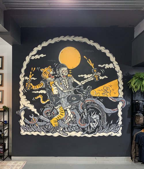 Illustration of a tiger and skeleton riding a motorcycle, stylized with a full moon, comic book effects, and graffiti art elements.