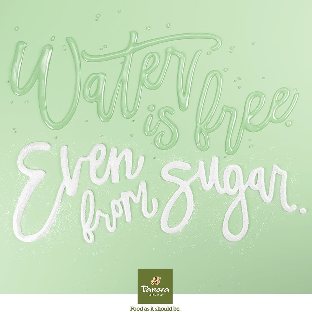 Stylized water and sugar lettering spells 'Water is free. Even from sugar.' set against a light green background, food and beverage advertisement.