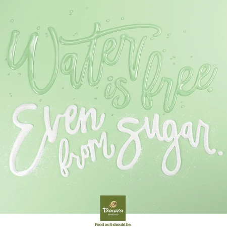 CGI typography spelling out Water is free, even from sugar in glossy green and white lettering against a pale green background.