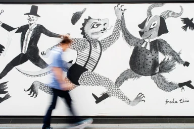 Monochrome mural illustration with whimsical characters and a motion-blurred person walking past in Sydney.