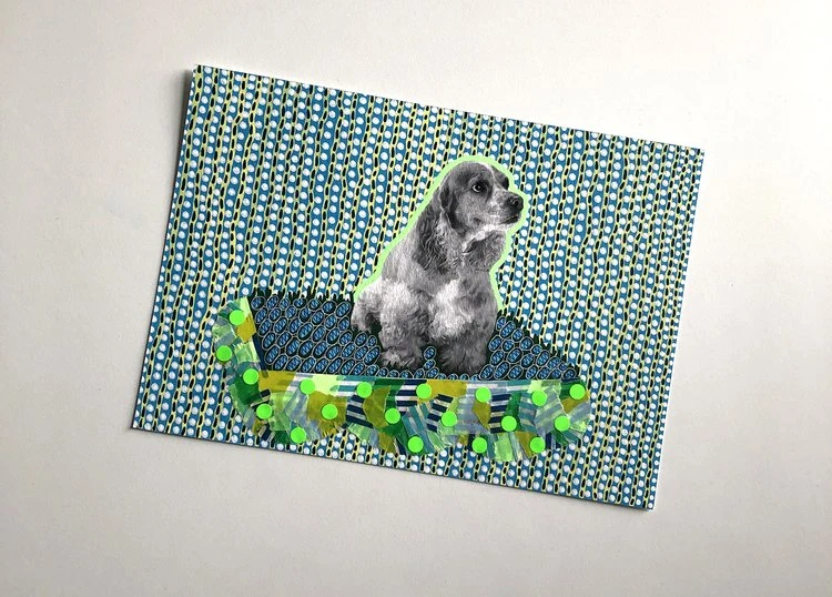 Collage artwork featuring a grey dog atop a blue and green decorative element against a blue and white patterned background.