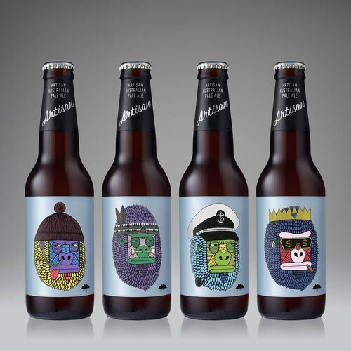 Four brown glass beer bottles with colorful gorilla cartoon labels aligned on a gray background. Artisan Australian Pale Ale branded.