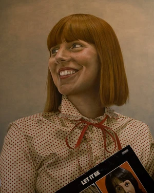 Portrait illustration of a smiling woman with red hair wearing a polka-dot collared shirt holding a vinyl record sleeve.