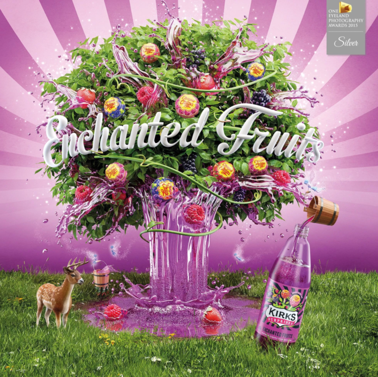 Whimsical composite image of fruit tree with Kirks soft drink bottle, a deer, and lush green grass against a pink radial gradient background.