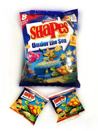 A package of Arnott's Shapes 'Under the Sea' crackers with cartoon sea-life illustrations, accompanied by two smaller snack packs.
