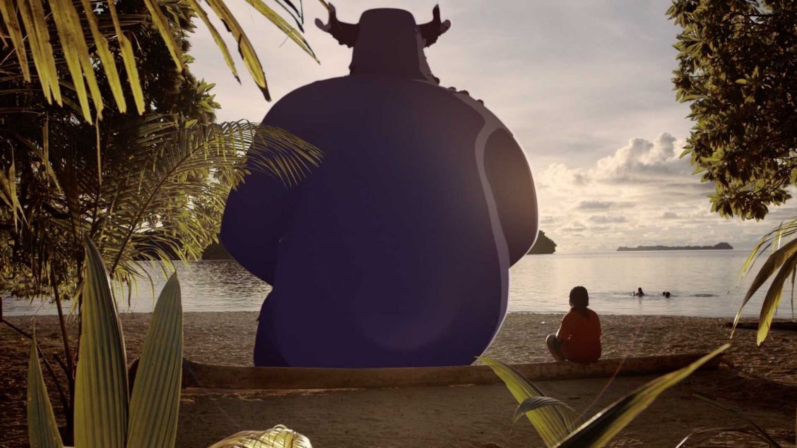 Fantasy illustration: A large, blue, horned creature sits on a beach as a child sits nearby facing the water and islands.