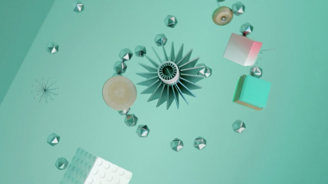 Abstract composition with geometric shapes in white, grey, green, and tan against a light teal background; artful arrangement.
