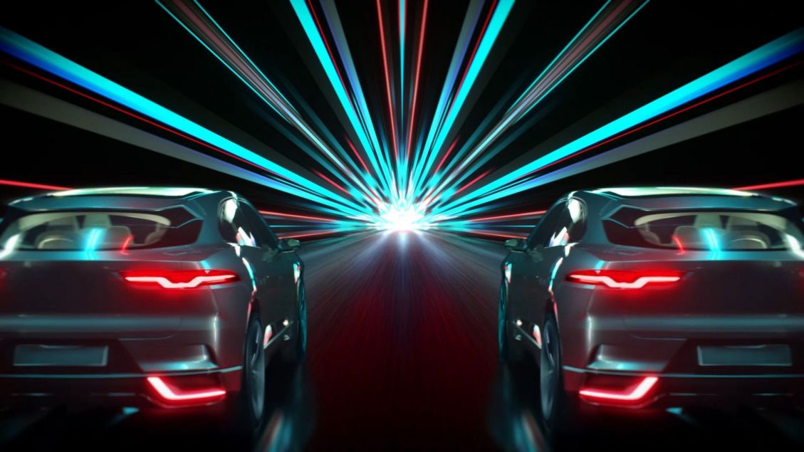 Two sport utility vehicles shown from the rear, symmetrically arranged with bright neon light trails behind them on a dark surface.