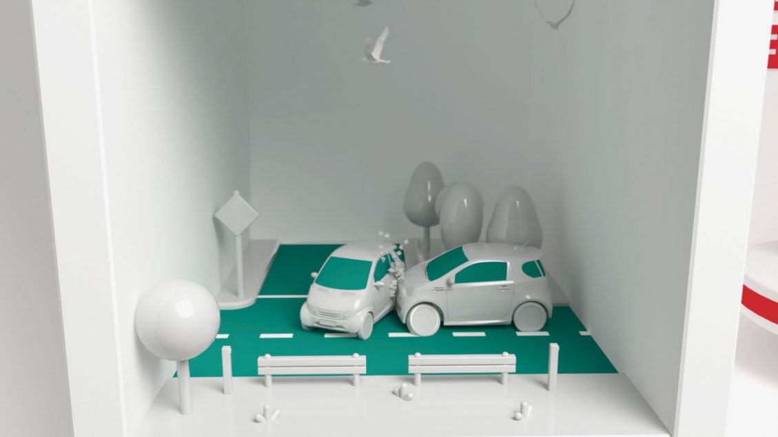 CGI illustration of two white toy cars colliding on a miniature road with benches and trees, presented inside a white cube.