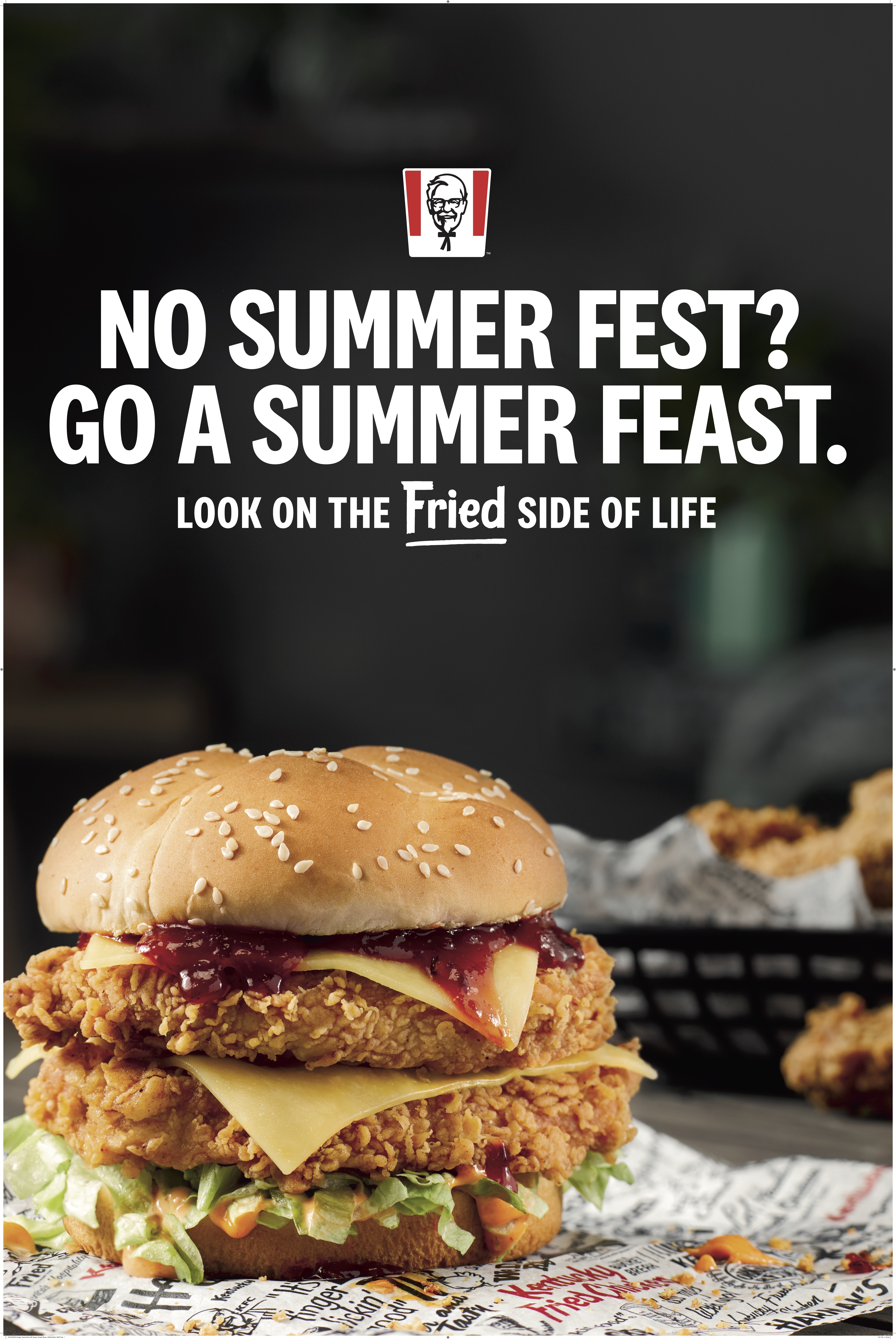 KFC double-layered fried chicken sandwich with cheese and sauce on a patterned surface, with KFC promotional text in the background.