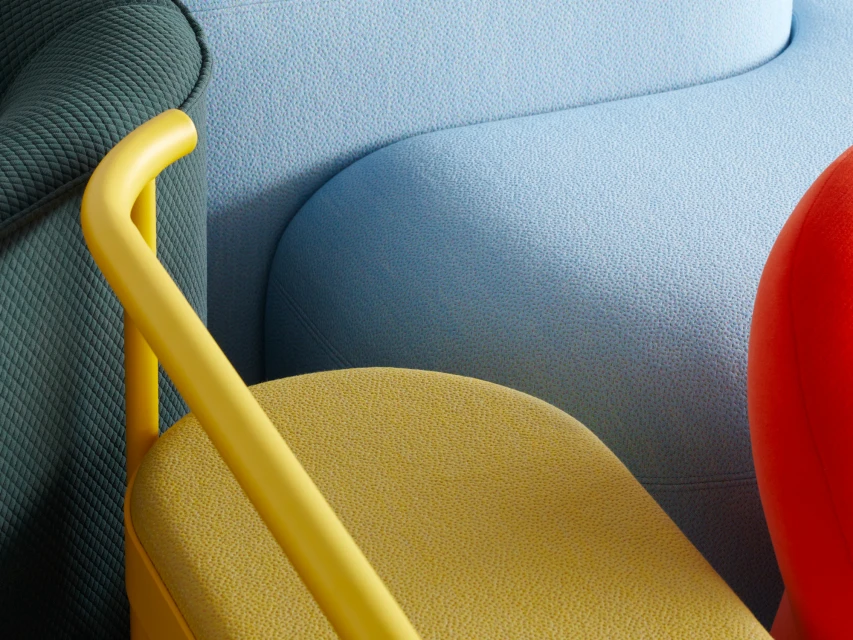 Abstract close-up of modern furniture with a yellow chair, blue couch, and red accents creating a colourful, textured interior design.