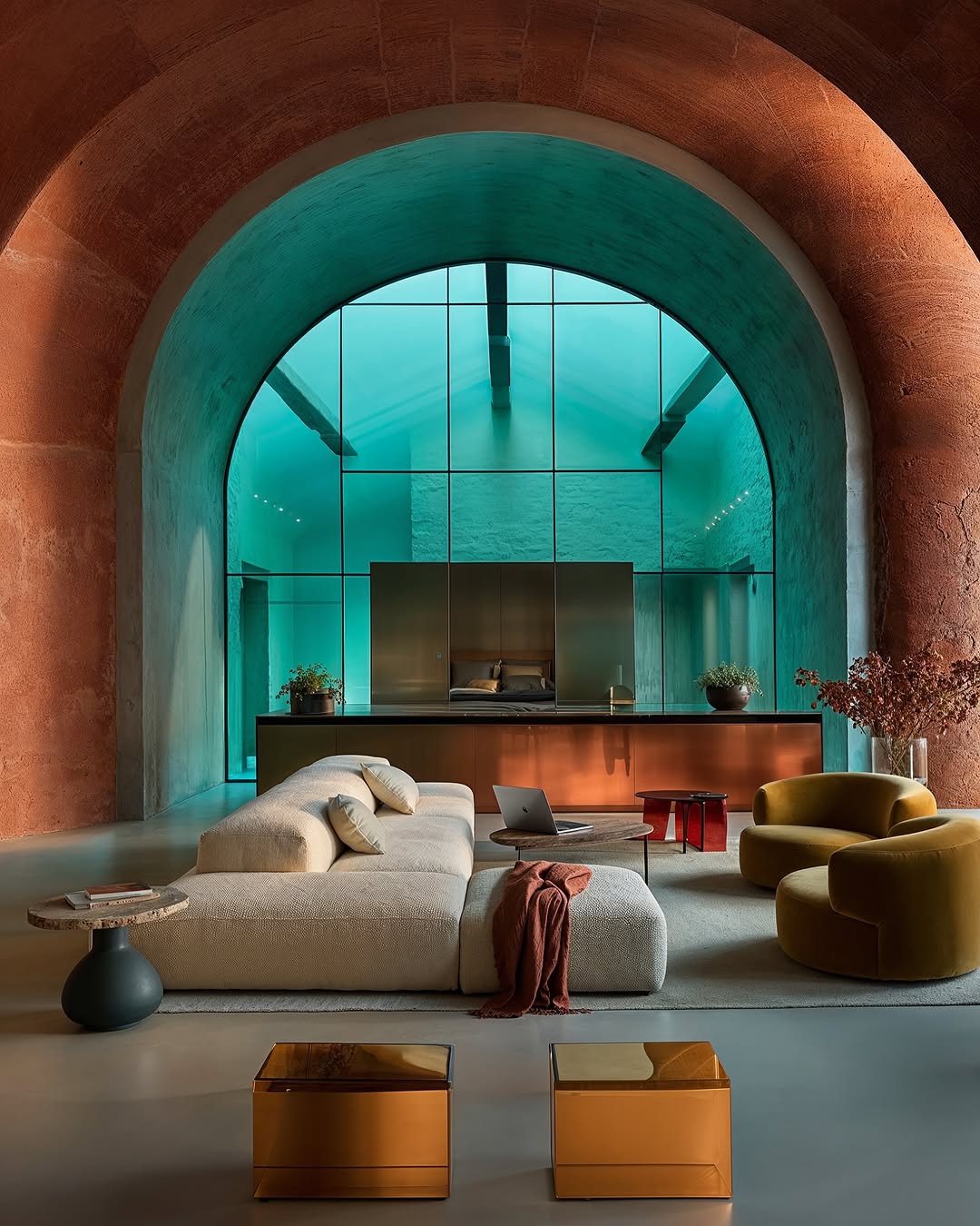 Architectural interior of a living room featuring a plush sofa, armchairs, and gold accent tables under an arched ceiling.