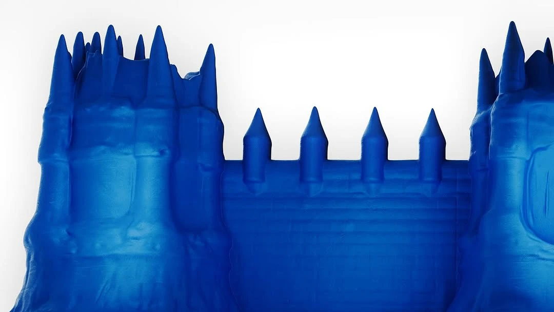 Close-up of a blue toy castle with many towers and spires, set against a clean white background, creating a crisp, studio-style image.