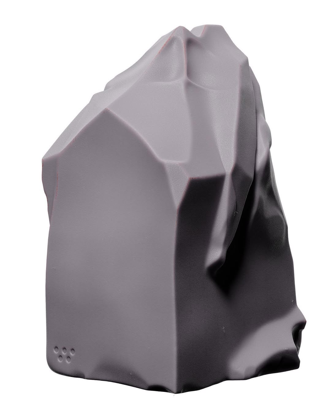 Grey, geometric rock formation against a white background, showcasing a blend of angular and smooth surfaces in a studio setting.