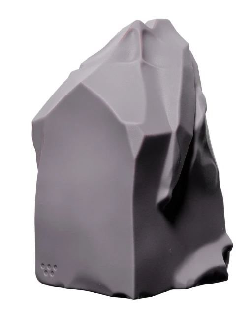 Grey, geometric rock formation against a white background, showcasing a blend of angular and smooth surfaces in a studio setting.