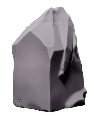 Grey, geometric rock formation against a white background, showcasing a blend of angular and smooth surfaces in a studio setting.