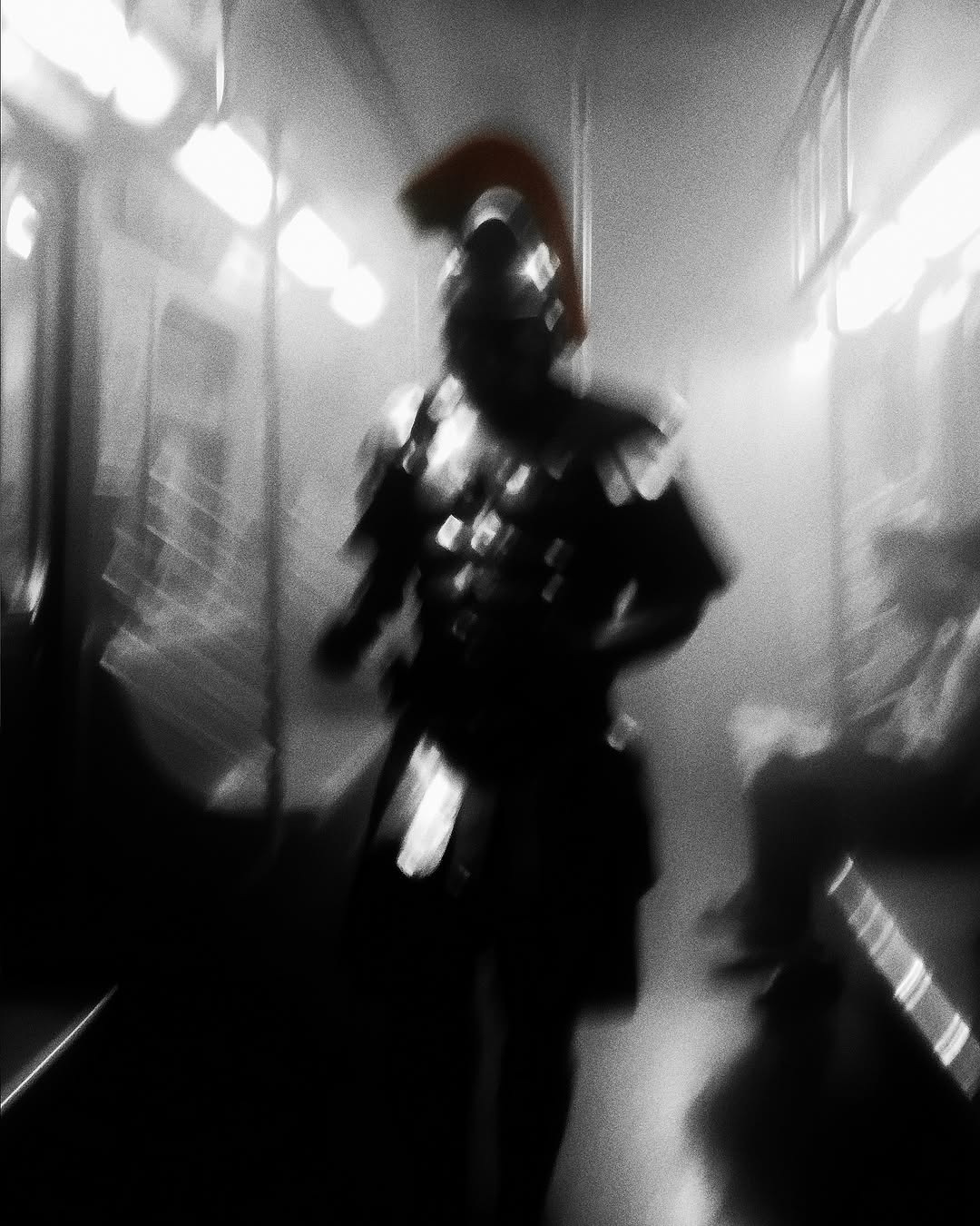 Motion blur of a person dressed in Roman armor on a subway train, creating a sense of surrealism and mystery in an urban setting.