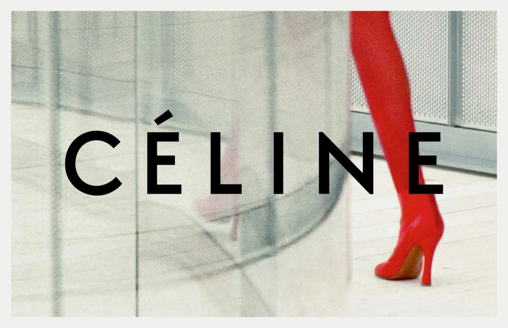 Fashion shoot featuring a model's legs in red shiny boots with a high heel. The brand name Celine is in big block letters.