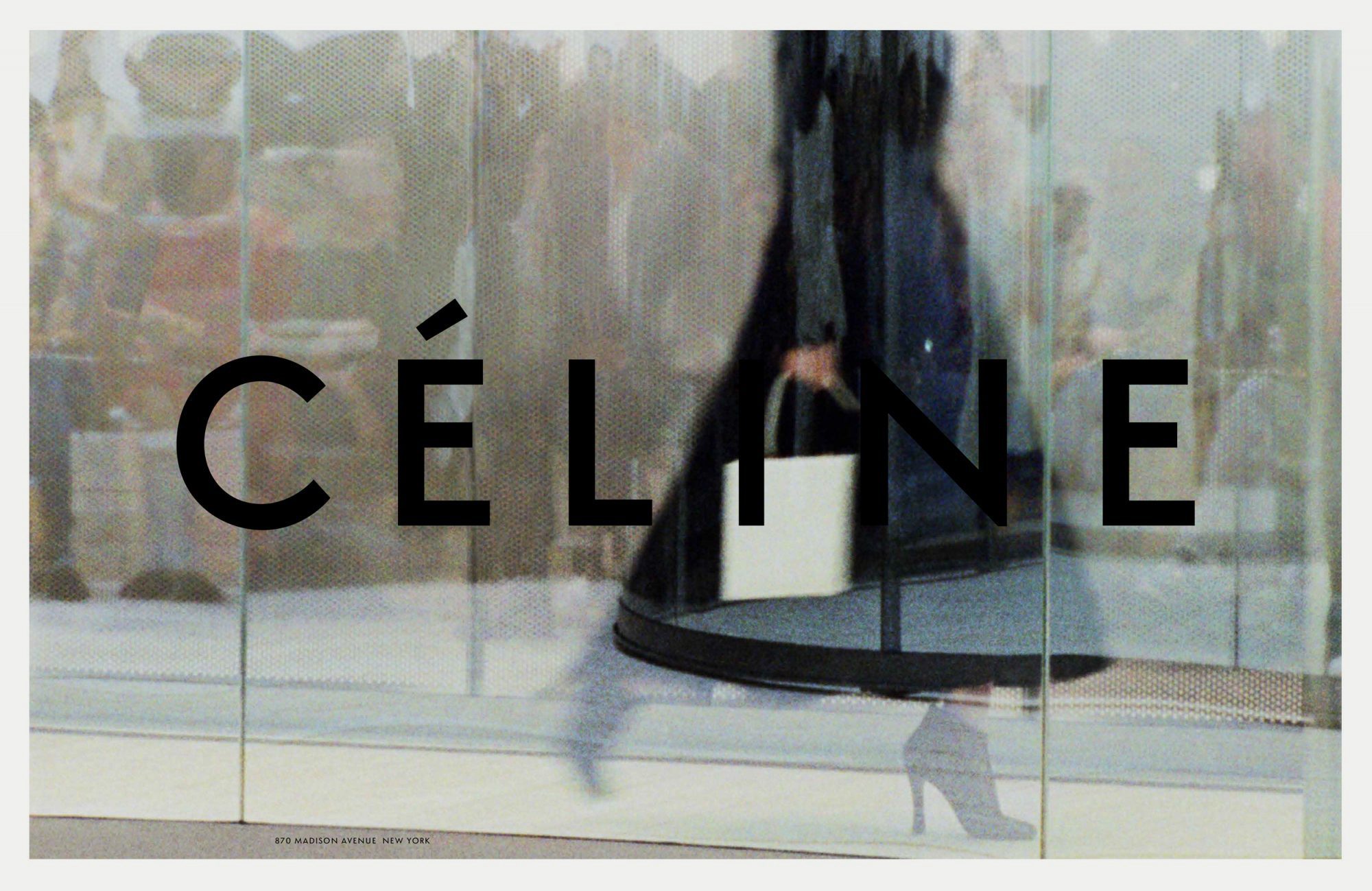 Fashion advertisement featuring a woman in heels and dark coat carrying a white handbag, walking past large Celine branded glass door.