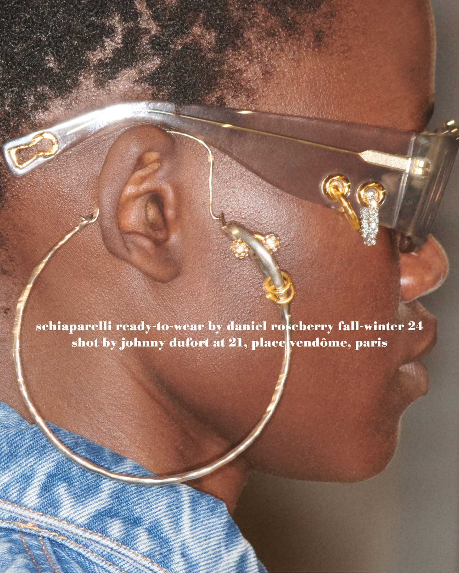Close-up of a Black woman's face wearing sunglasses and large hoop earrings, with text about fashion brand Schiaparelli.