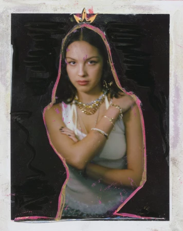 Portrait of Olivia Rodrigo with a black backdrop, adorned with a pink outline and a crown-like element, wearing a white top and jewelry.