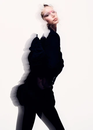Model in black clothing against a white background with multiple exposure effect by Zach Dean