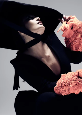 Model wearing an oversized black hat and ruffled peach sleeves by photographer Zach Dean in Melbourne.