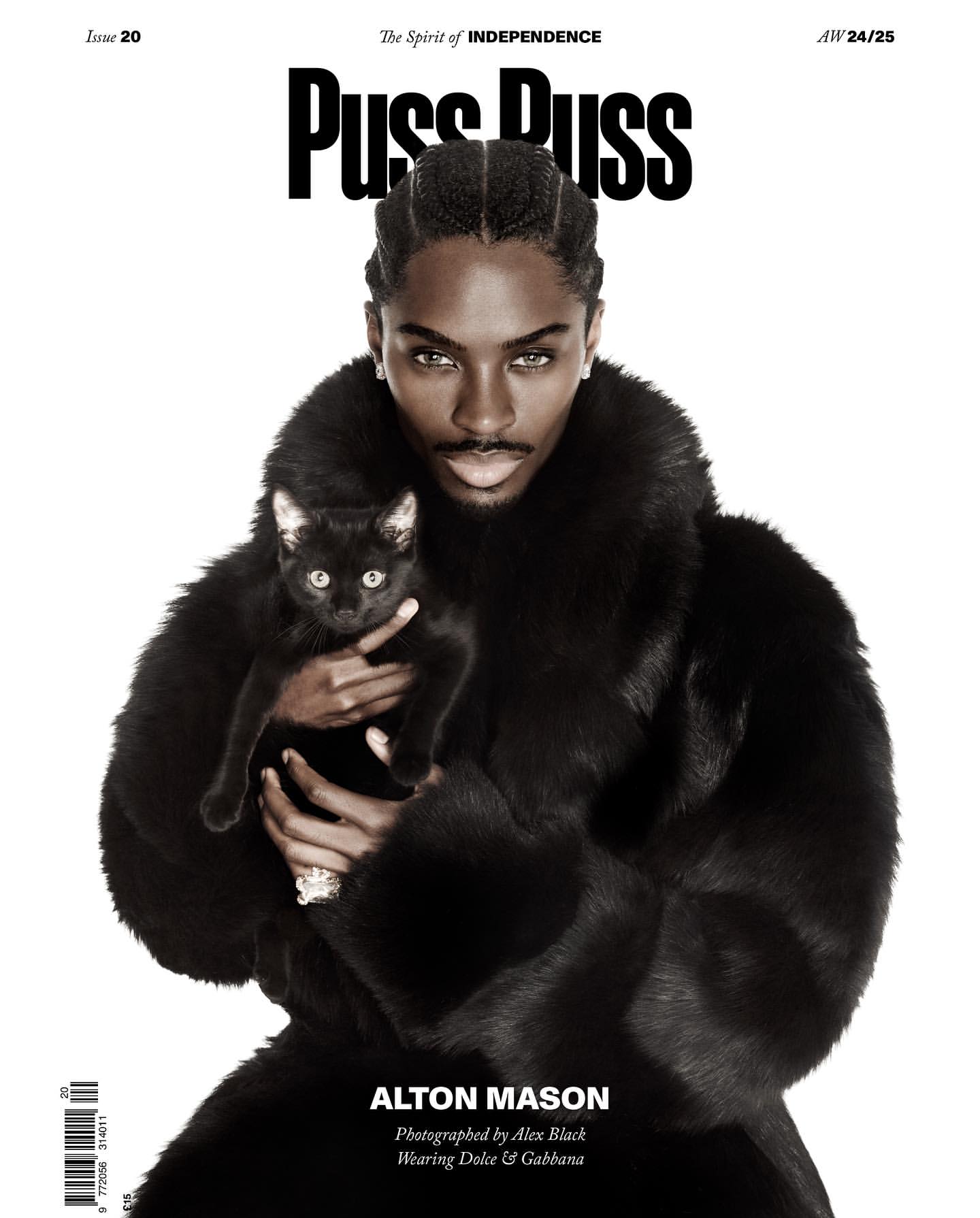 Magazine cover featuring a male model holding a black cat, wearing a fur coat, photographed for 'Puss Puss' magazine.