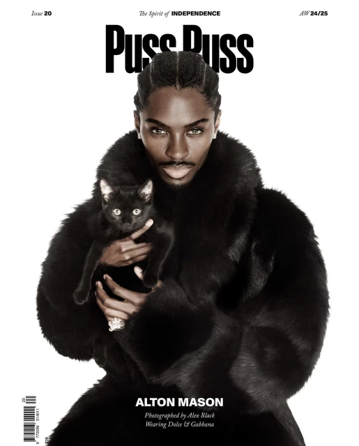 Magazine cover featuring a male model holding a black cat, wearing a fur coat, photographed for 'Puss Puss' magazine.