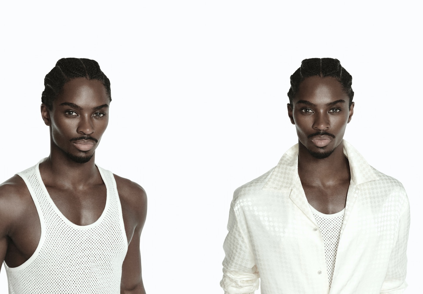 Close-up studio portrait of a Black man with braided hair wearing a white shirt with two mirrored images on a white background.