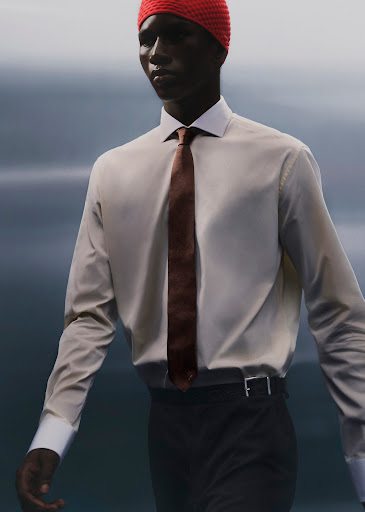 An African-American adult male wears a red knit cap, white collared shirt, brown tie, and black pants against a neutral background in a fashion shot.