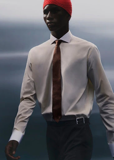 An African-American adult male wears a red knit cap, white collared shirt, brown tie, and black pants against a neutral background in a fashion shot.