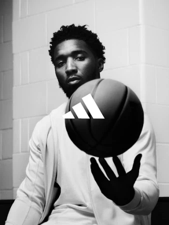 Black and white portrait of a black man spinning a basketball on his finger, directed by Alex Black.