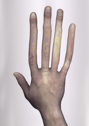 Close-up of a hand, showing all five fingers, palm facing up, skin texture, and colorful light patterns on fingers. Against white backdrop.