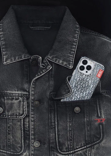 Close-up studio shot of a black denim jacket with an iPhone in the pocket, showcasing a casual fashion style and modern technology.