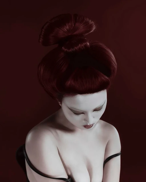Woman with pale skin and high auburn hairstyle poses against a dark red background in a portrait. Beauty and fashion editorial.