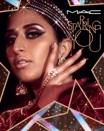 Close-up of a glamorous Indian woman wearing MAC makeup and sparkling jewelry, set against a backdrop of geometric shapes and golden sparkles.