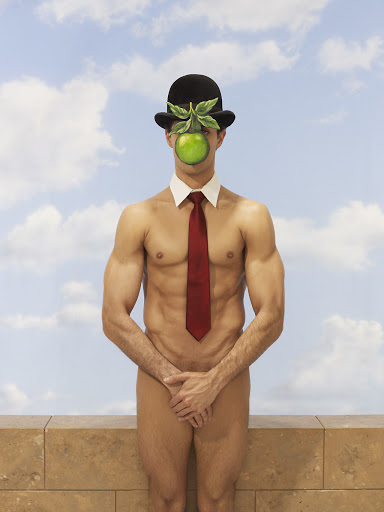 Surreal image of a shirtless man wearing a bowler hat with an apple covering his face, posing in front of a cloudy sky and a low wall.
