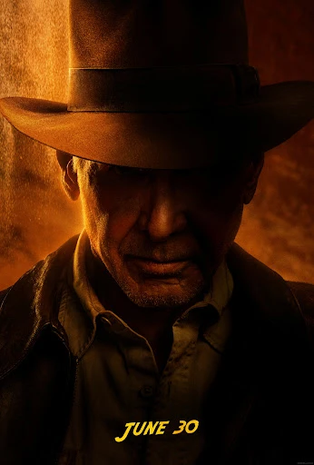 Close-up promotional image of Harrison Ford as Indiana Jones wearing a fedora and jacket against a warmly-lit background.