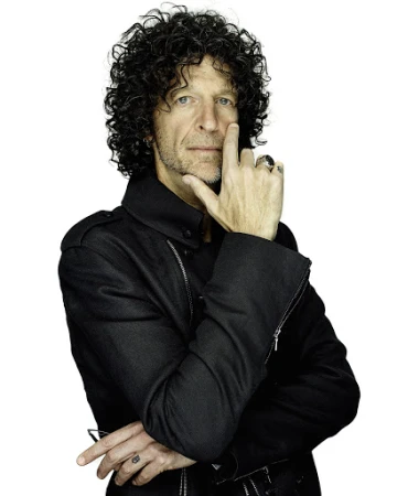 Portrait of an adult male with dark curly hair, wearing a black jacket, his fingers touching his face, against a white backdrop.