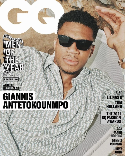 GQ magazine cover featuring Giannis Antetokounmpo in sunglasses and patterned shirt, posing outdoors with rock background and magazine text.